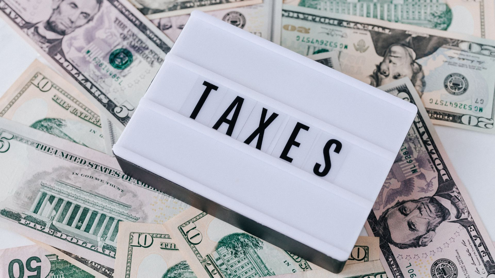 Tax documents and money representing tax preparation